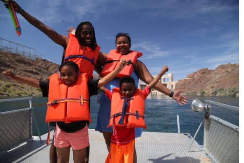 A family Exploring the Colorado River on a boat.