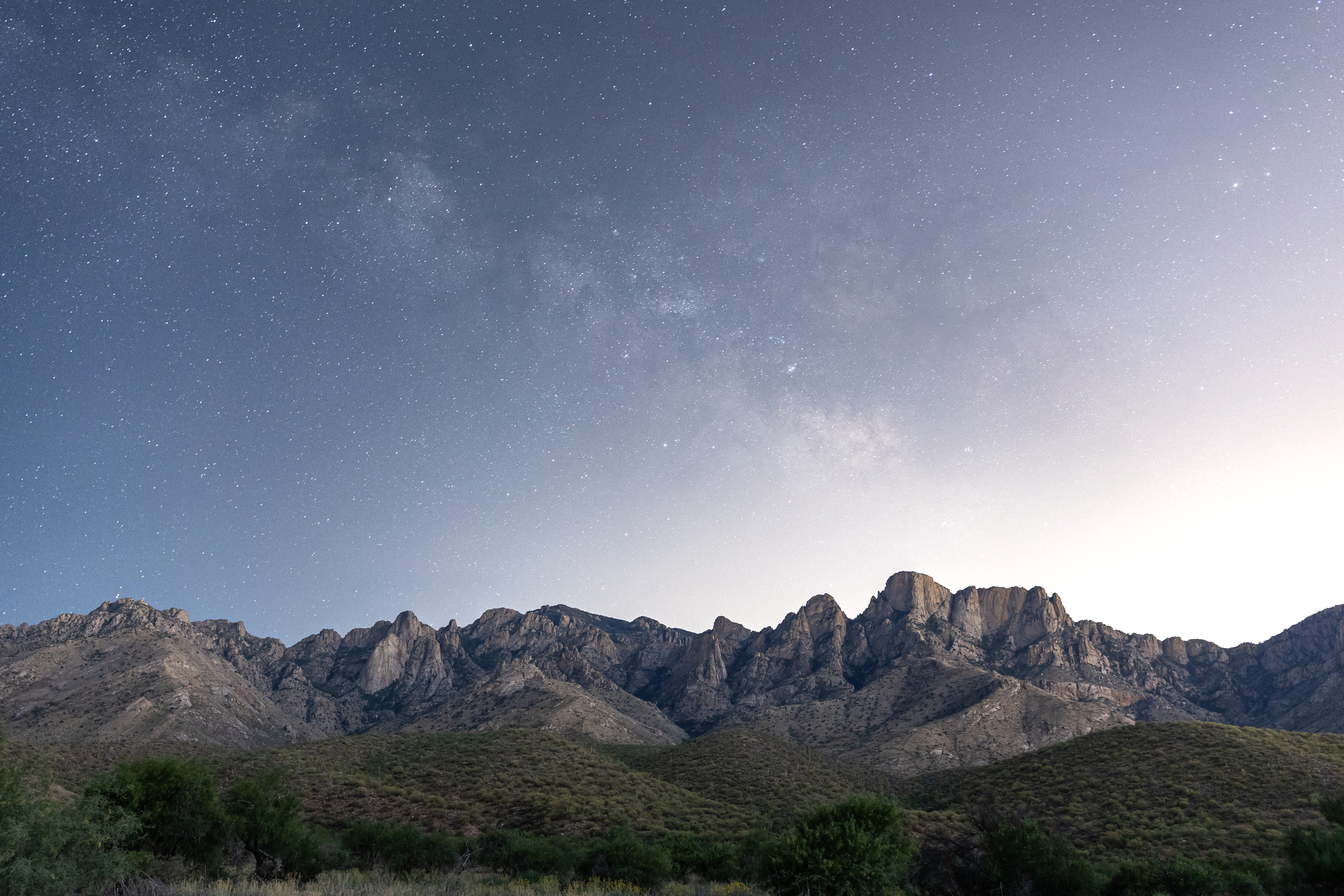 The night sky glows over the Catalina Mountains