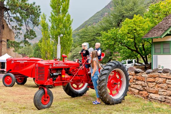 A tractor with children on it at a previous Fall Fest