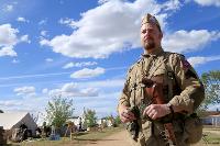 man in historic military uniform with clouds in the blue sky background