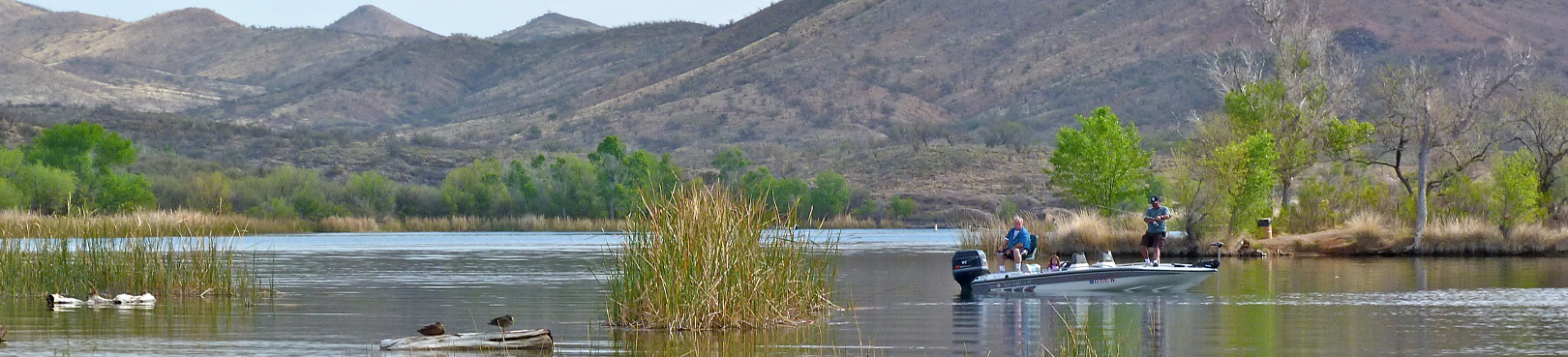 A fishing boat sits on the water at Patagonia Lake State Park